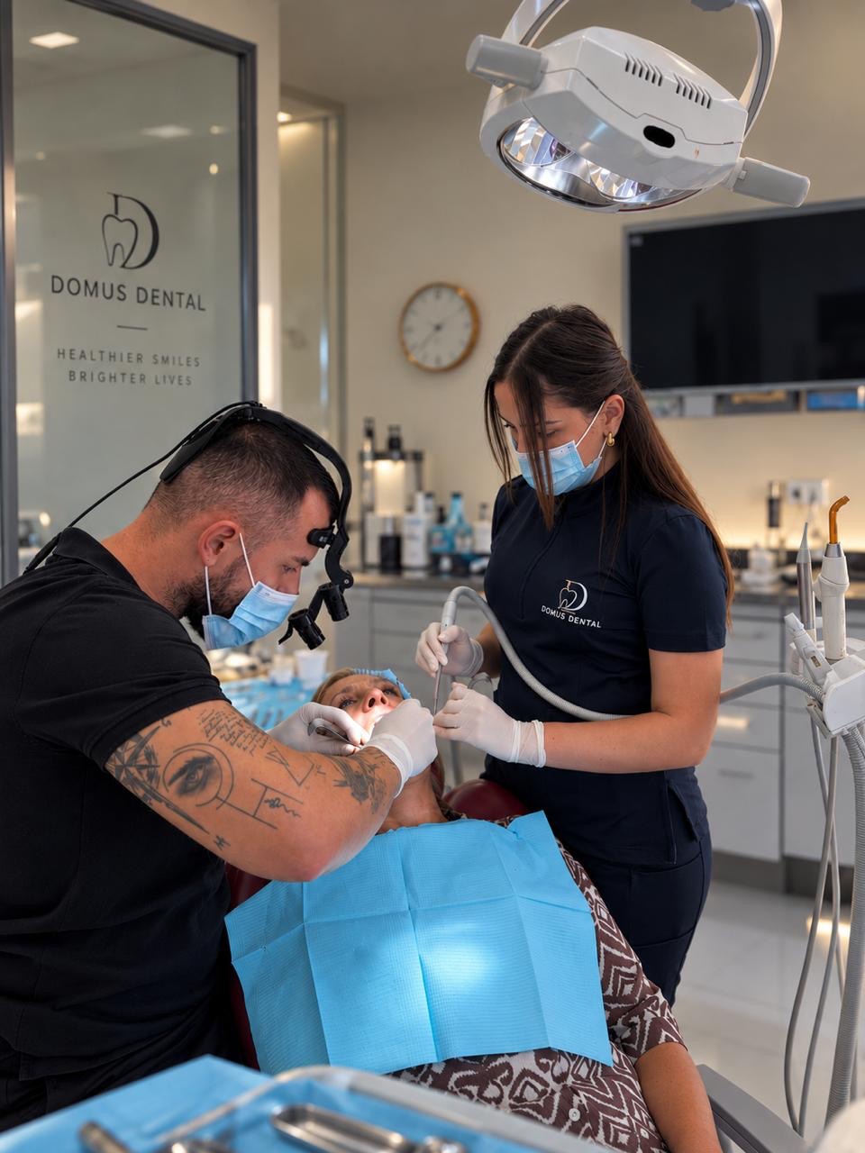 Domus Dental dentist and assistant treating a patient in the Tirana clinic